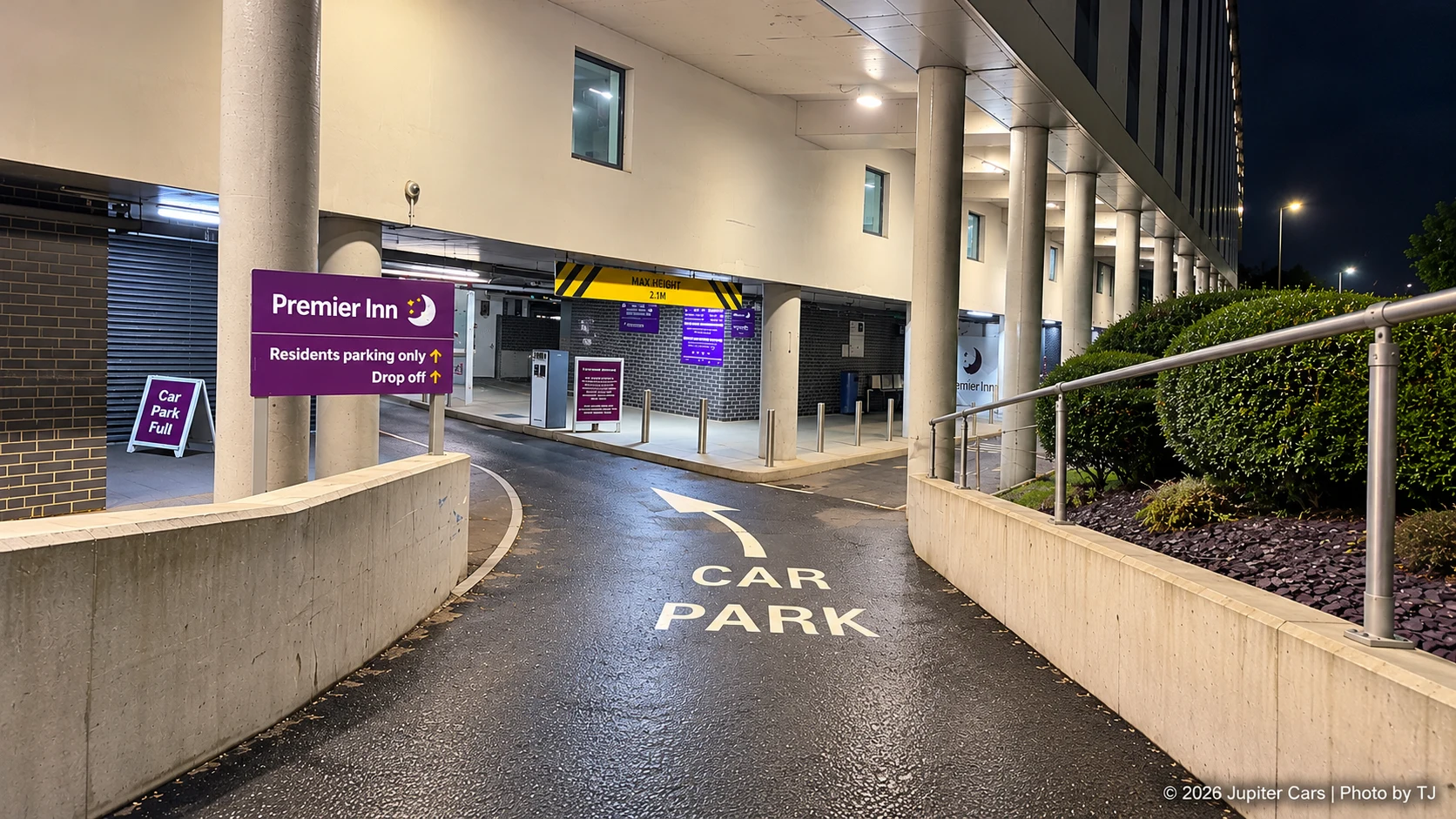 Premier Inn car park ramp with residents parking and drop-off signs and a 2.1 metre height restriction